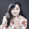 Woman with dark hair posing for a headshot